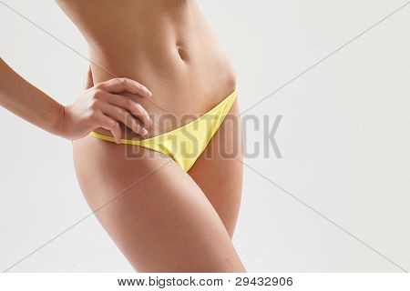 Stock foto af unge, pasform og sexet kvinde i gul badedragt