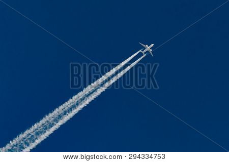 Airplanes Leaving Contrail Trace On A Clear Blue Sky