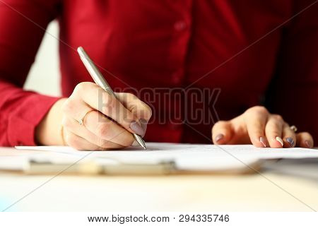 Female Office Worker Holding Silver Pen Filling Out Some Application Form Closeup