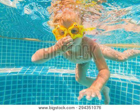 Little Girl Deftly Swim Underwater In Pool