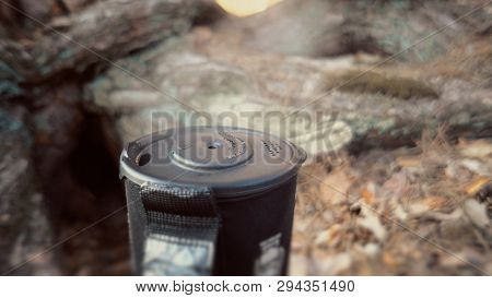 Close-up Of A Gas Burner, On Which A Kettle With A Lid Stands, Boils Water, Steam, Cooking In Outdoo