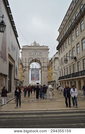 Augusta Street With The Arch In The Background With A Back Street Mime In Lisbon. Nature, Architectu