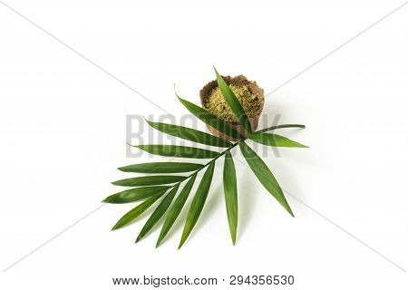 Henna Powder For Dyeing Hair And Eyebrows And Drawing Mehendi On Hands, Isolate With Green Palm Leaf
