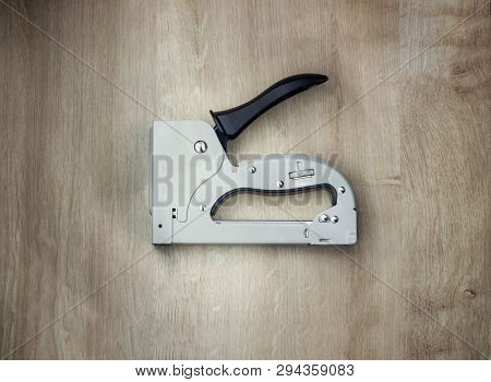 The Furniture Stapler On Wood Background Close-up.