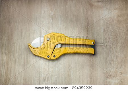 Special Scissors For Cutting Polypropylene Pipe On Wooden Backgroung.