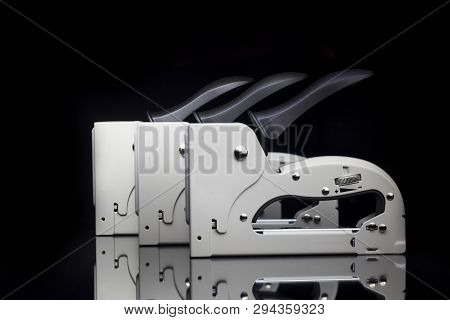 Industrial Staple Gun Isolated On Black Background.
