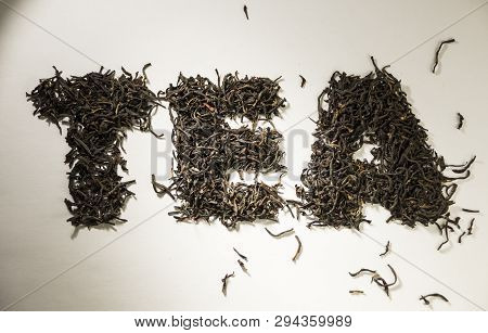 Inscription Tea From Black Tea Leaves On A White Background