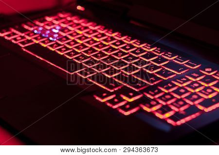 Close Up. Red Backlight Of Laptop Keyborad. Gaming Computer In The Dark. Computer Laptop Keyboard Wi