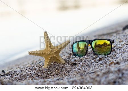 Summer Time Concept With A Starfish And Glasses On A Seashore Beach Background