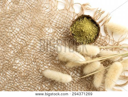 Henna Powder For Dyeing Hair And Eyebrows And Drawing Mehendi On Hands, Isolate With Green Palm Leaf