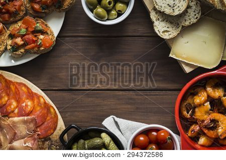 Tapas Dishes Arranged Around Clear Copy Space To Form A Frame. Dishes Include Meat And Charcuterie, 