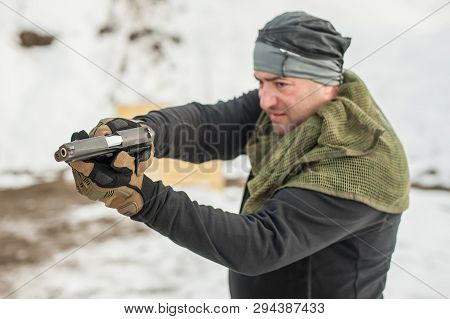 Shooter Holding Gun In Hand And Shooting. Close-up Detail View