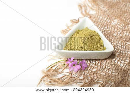 Henna Powder For Dyeing Hair And Eyebrows And Drawing Mehendi On Hands, Isolate With Green Palm Leaf