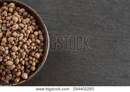 Lot Of Whole Brown Clay Pebbles (leca) On Grey Ceramic Plate Flatlay On Grey Stone