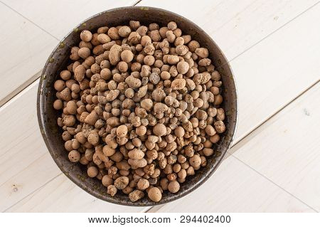 Lot Of Whole Brown Clay Pebbles (leca) On Grey Ceramic Plate Flatlay On White Wood