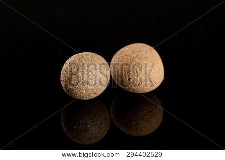 Group Of Two Whole Brown Clay Pebbles (leca) Isolated On Black Glass
