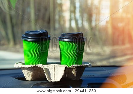 Two Green Paper Cups With Tea Or Coffee For A Couple In Car On Sunny Blurred Background. Takeaway, S