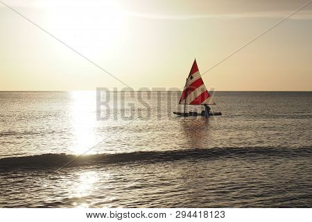 Captiva Island, Florida 08-05-2015 Active Senior Sails A Sunfish In Late Afternoon Light Off The Bea