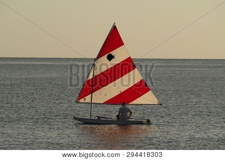 Captiva Island, Florida 08-05-2015 Active Senior Sails A Sunfish In Late Afternoon Light Off The Bea
