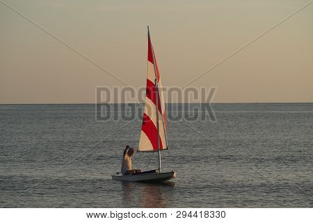 Captiva Island, Florida 08-05-2015 Active Senior Sails A Sunfish In Late Afternoon Light Off The Bea