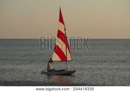 Captiva Island, Florida 08-05-2015 Active Senior Sails A Sunfish In Late Afternoon Light Off The Bea