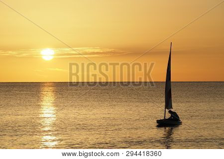 Captiva Island, Florida 08-05-2015 Active Senior Sails A Sunfish In Late Afternoon Light Off The Bea