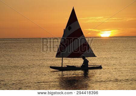 Captiva Island, Florida 08-05-2015 Active Senior Sails A Sunfish In Late Afternoon Light Off The Bea