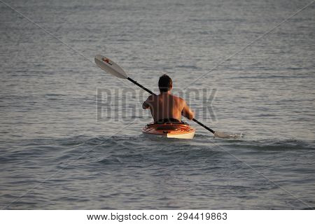 Captiva Island, Florida 08-05-2015 Young Man Kayaks Off The Beach In Captiva Island In Partial Silho