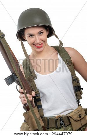 A Pretty Young Woman Dressed In Wwii Military Uniform With Helmet And Rifle