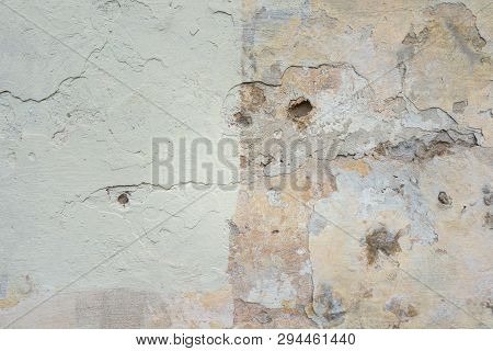 Old Wall With Peel Grey Stucco Texture. Retro Vintage Worn Wall Background. Decayed Cracked Rough Ab