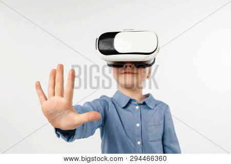 Touching Nonexistent. Little Girl Or Child In Jeans And Shirt With Virtual Reality Headset Glasses I