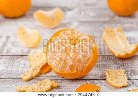 Peele Dripe Tangerines On Wooden Light Background