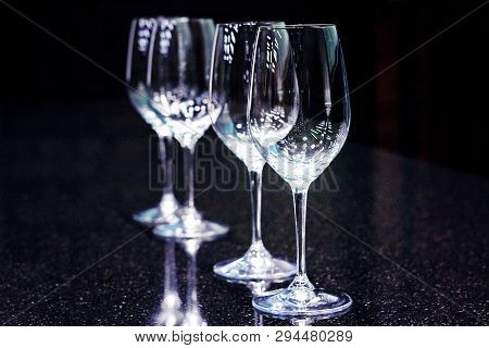 Sommelier, Cavist. 4 Empty Wine Glasses On A Dark Background. Wine School. Tinted
