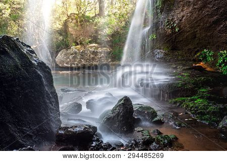 Waterfall Cascades Over Rock Ledges As It Meanders Through Beautiful Australian Bushland