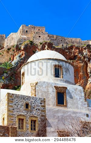 Monemvasia, Greece Street Panorama With Old Houses And Elkomenos Christos Church In Ancient Town, Pe
