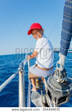 Little Boy On Board Of Sailing Yacht On Summer Cruise. Travel Adventure, Yachting With Child On Fami