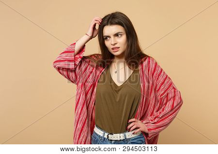 Portrait Of Preoccupied Young Woman In Casual Clothes Looking Aside, Putting Hand On Head Isolated O