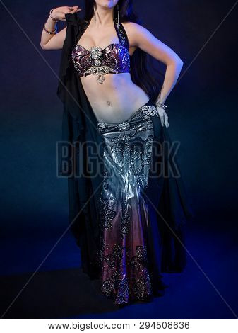 Girl With A Gorgeous Figure Poses In A Beautiful Black Dress For Belly Dancing, Fusion, Tribal. A Wo