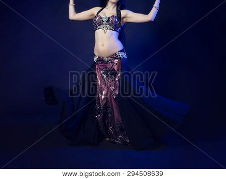 Girl With A Gorgeous Figure Poses In A Beautiful Black Dress For Belly Dancing, Fusion, Tribal. A Wo