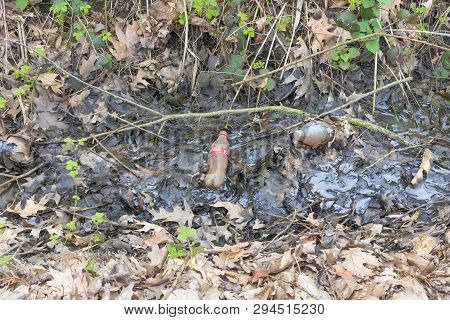 Belgium, Sint Gillis Waas 8 April 2019, Plastic Bottles In The Ditch Next To A Meadow Where Cows Gra