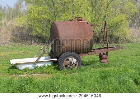 Rusty Drinking Water Tank For Cows With A Bathtub As Drinking Trough