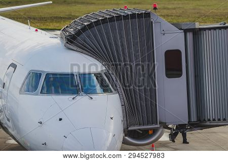 Jetway Connected To The Airplane For Boarding Passengers. Boarding Bridge.
