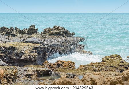 Beach Rocks, Sea Water Hitting The Rocks On The Bay. Pointed Spongy Rocks. Set Of Rocks Near The Sea