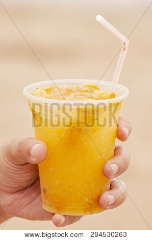 Hand Holding A Caipirinha De Seriguela Drink. An Alcohol Drink With Spondias Fruit, Typical Of Brazi