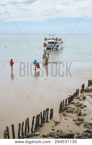 Joao Pessoa - Pb, Brazil - February 21, 2019: Tourists Entering The Sea To Reach The Catamaran At Be