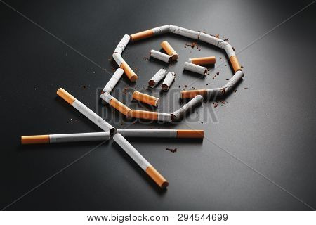 Skull From Cigarettes On A Black Background. The Concept Of Smoking Kills. Toward The Concept Of Smo