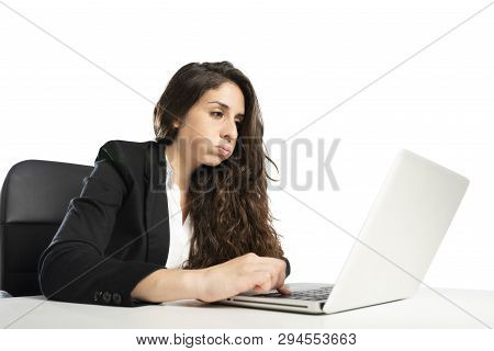 Bored Woman Snorts In The Office While Working On The Laptop