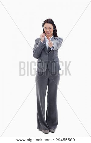 Businesswoman approving with a headset against white background