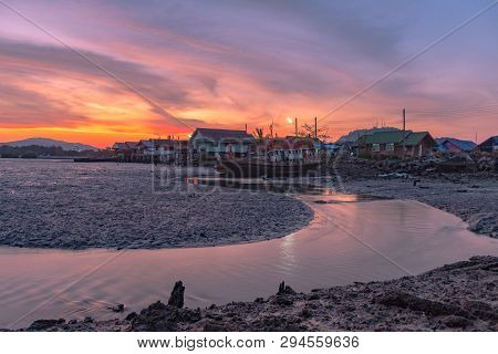 Stunning Sunset At Fishing Village In Phuket.during Low Tide Will Has A Small Canal Beside Fishing V