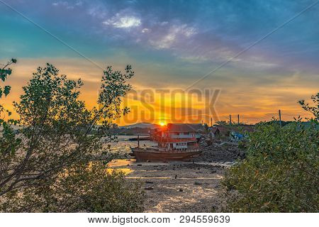 Stunning Sunset At Fishing Village In Phuket.during Low Tide Will Has A Small Canal Beside Fishing V
